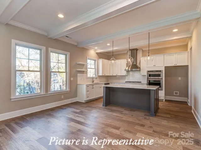 a large kitchen with kitchen island a sink stainless steel appliances and cabinets