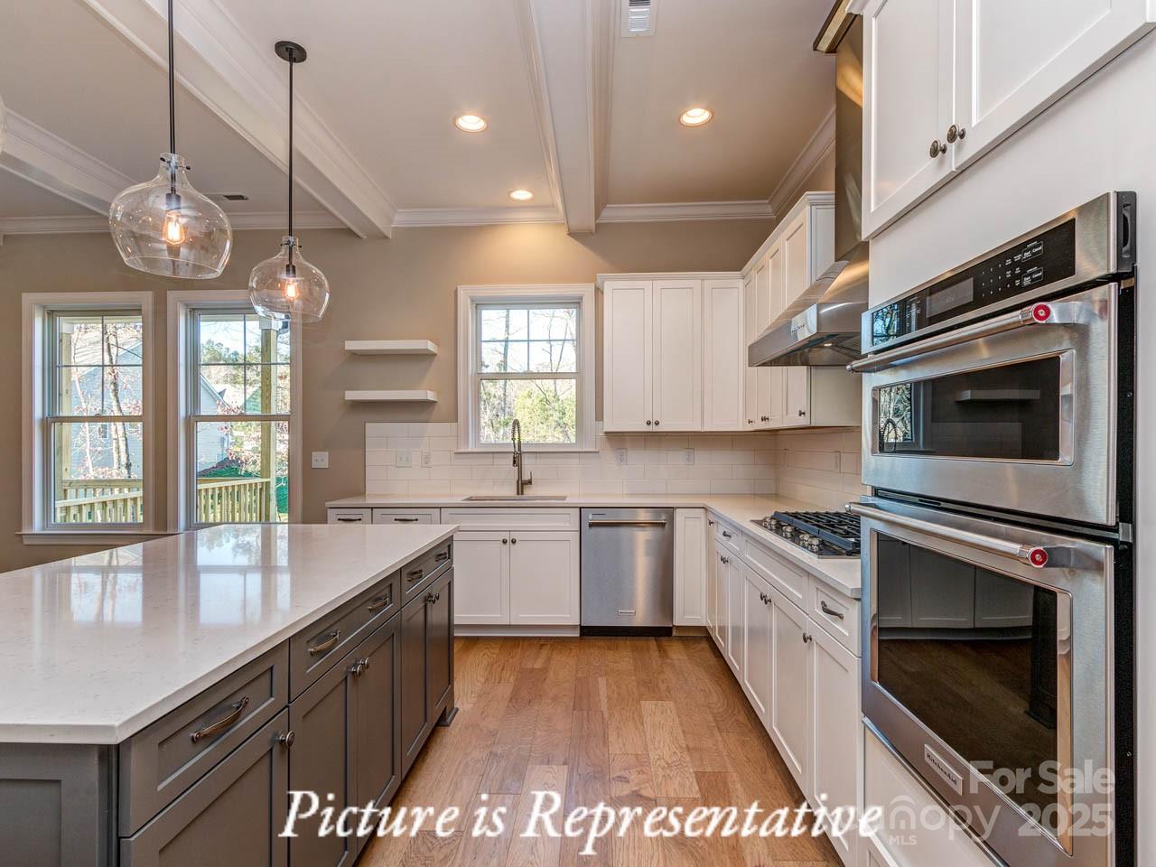4238 Brushy Knoll York, SC 29745 - Photo 18 of 46 a large kitchen with granite countertop a stove a sink a window and cabinets