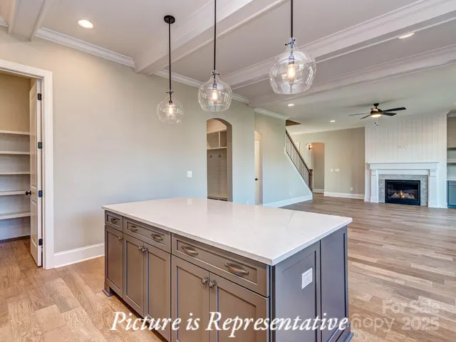 a view of a kitchen center island and stainless steel appliances