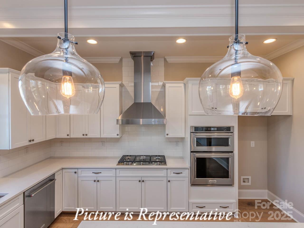 4238 Brushy Knoll York, SC 29745 - Photo 21 of 46 a kitchen with stainless steel appliances a stove a counter space a sink and cabinets