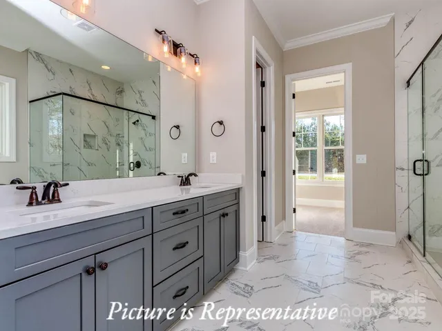 a spacious bathroom with a granite countertop sink mirror and shower