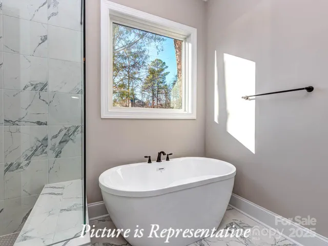 a bathroom with a bathtub and a window