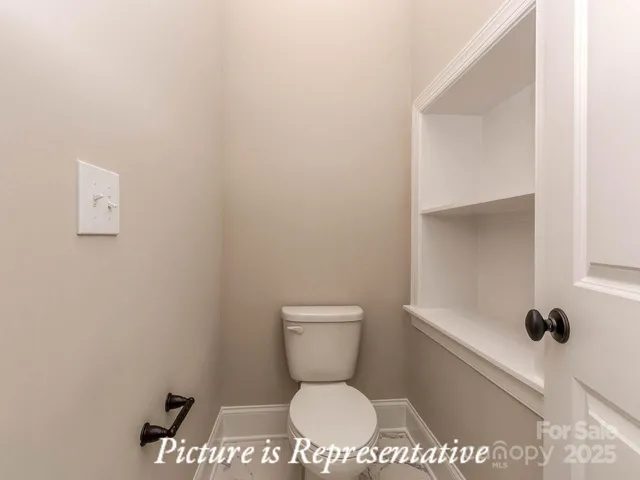 a bathroom with a toilet and a vanity