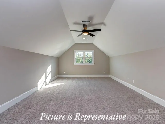 an empty room with a window and a ceiling fan