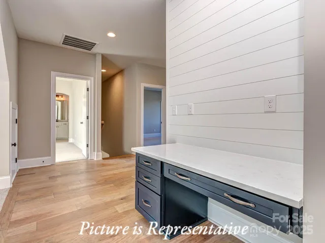 a view of bathroom with a sink and mirror