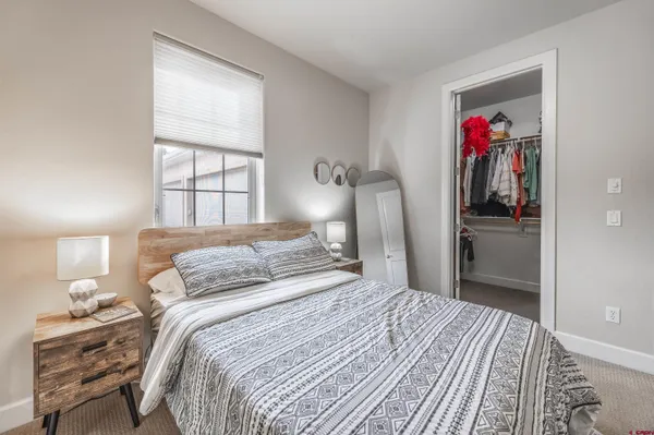 a spacious bedroom with a bed and a window