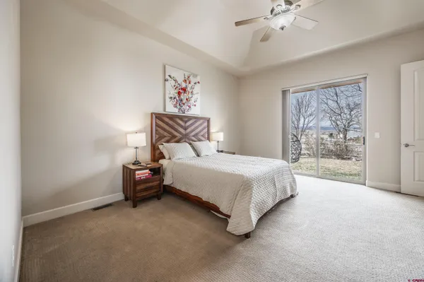 a bedroom with a bed and a ceiling fan