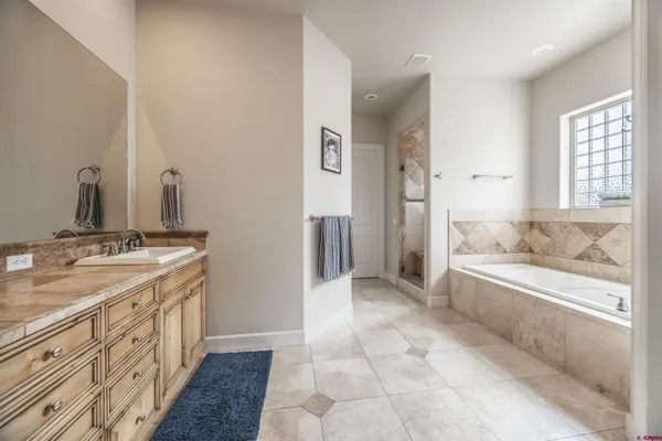a bathroom with a tub and a shower