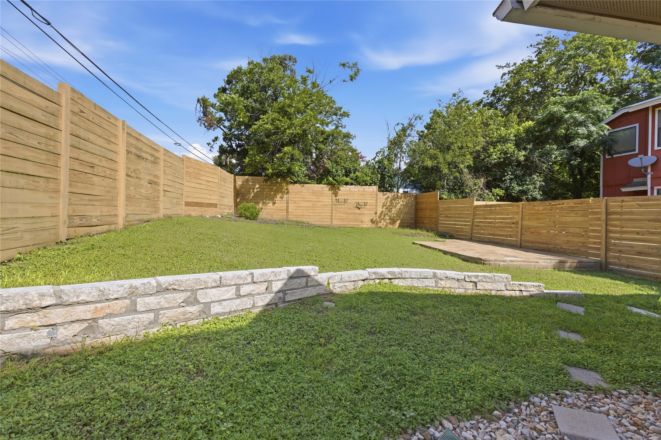 4124 Valley View Road, Unit 4A & 4B Austin, TX 78704 - Photo 13 of 40 A tiered backyard features fresh grass, privacy fencing, and a sun-soaked patio area.