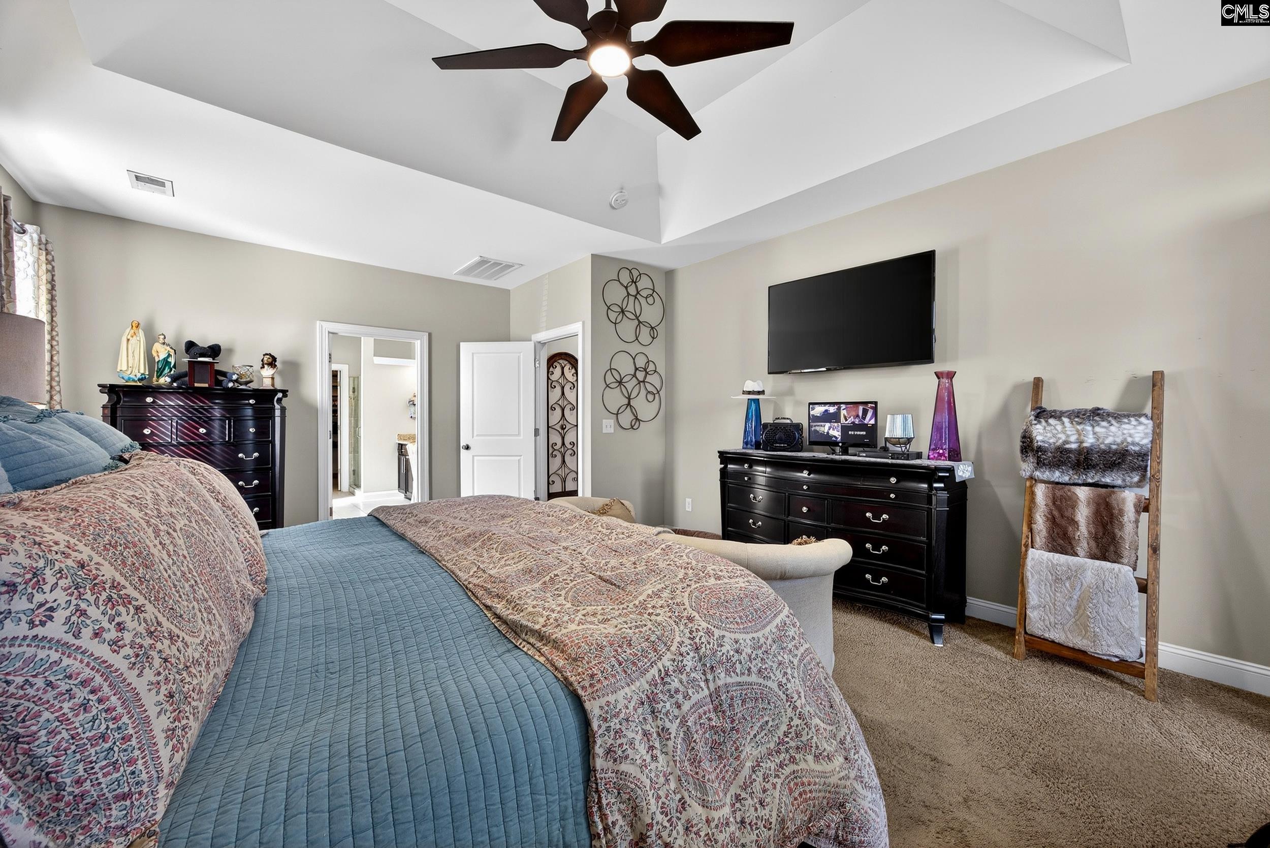 116 Renard Way Gilbert, SC 29054 - Photo 36 of 74 a bedroom with a bed and a flat screen tv