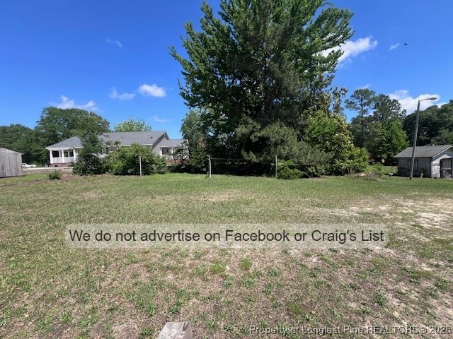 99 Susan Street Clinton, NC 28328 - Photo 9 of 10 a view of a field with an trees