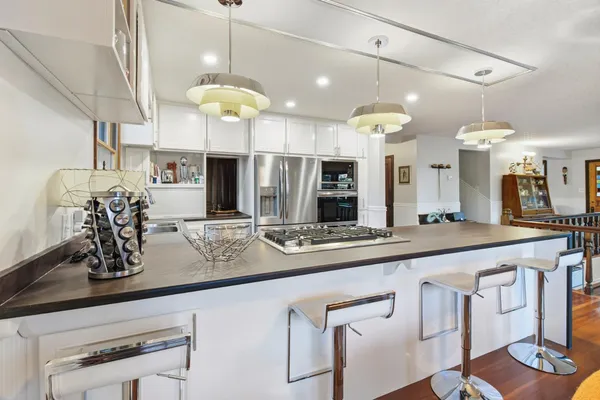 a large kitchen with stainless steel appliances sink microwave and cabinets