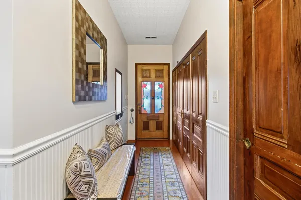 a view of a porch with wooden floor and windows