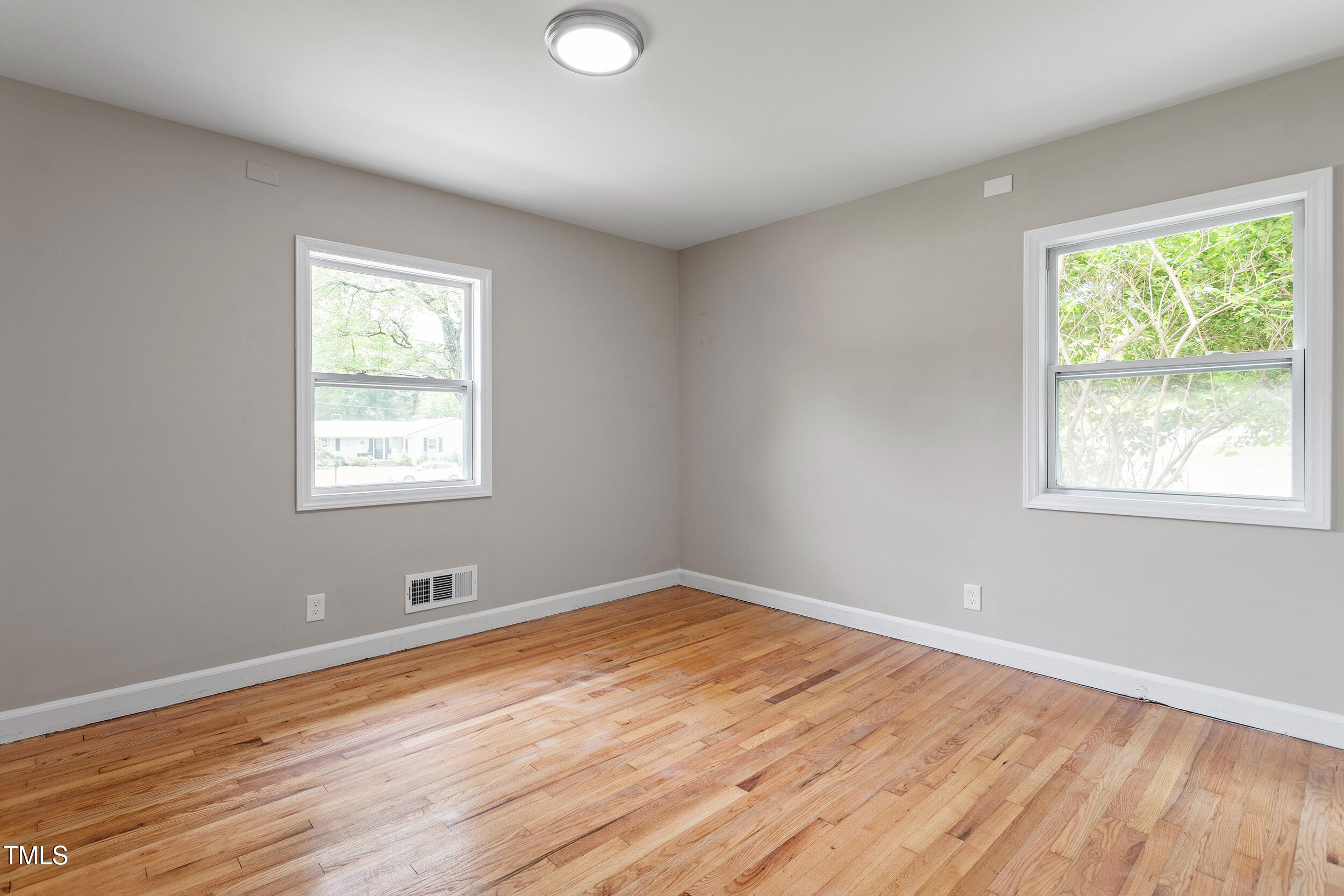 3325 Old Buffalo Road Raleigh, NC 27604 - Photo 14 of 26 an empty room with wooden floor and windows