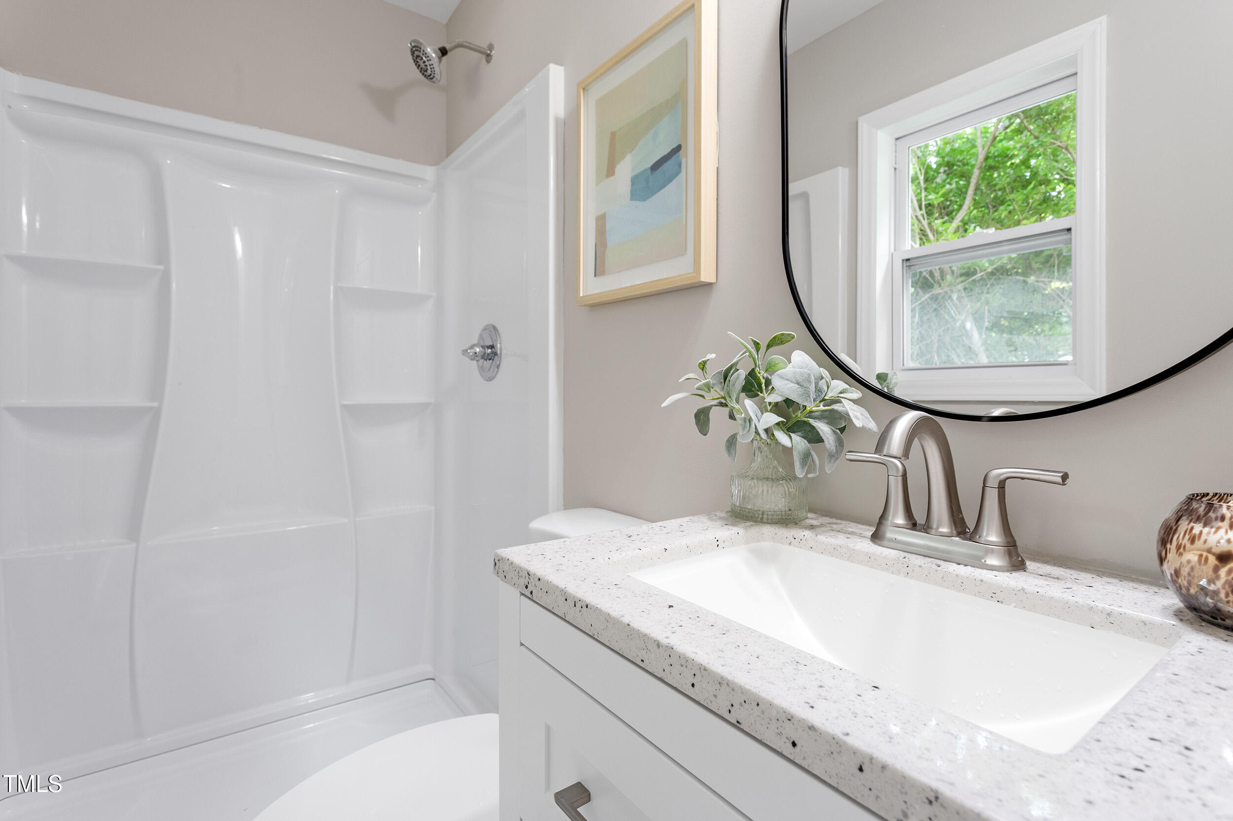 3325 Old Buffalo Road Raleigh, NC 27604 - Photo 17 of 26 a bathroom with a granite countertop sink a mirror and a shower