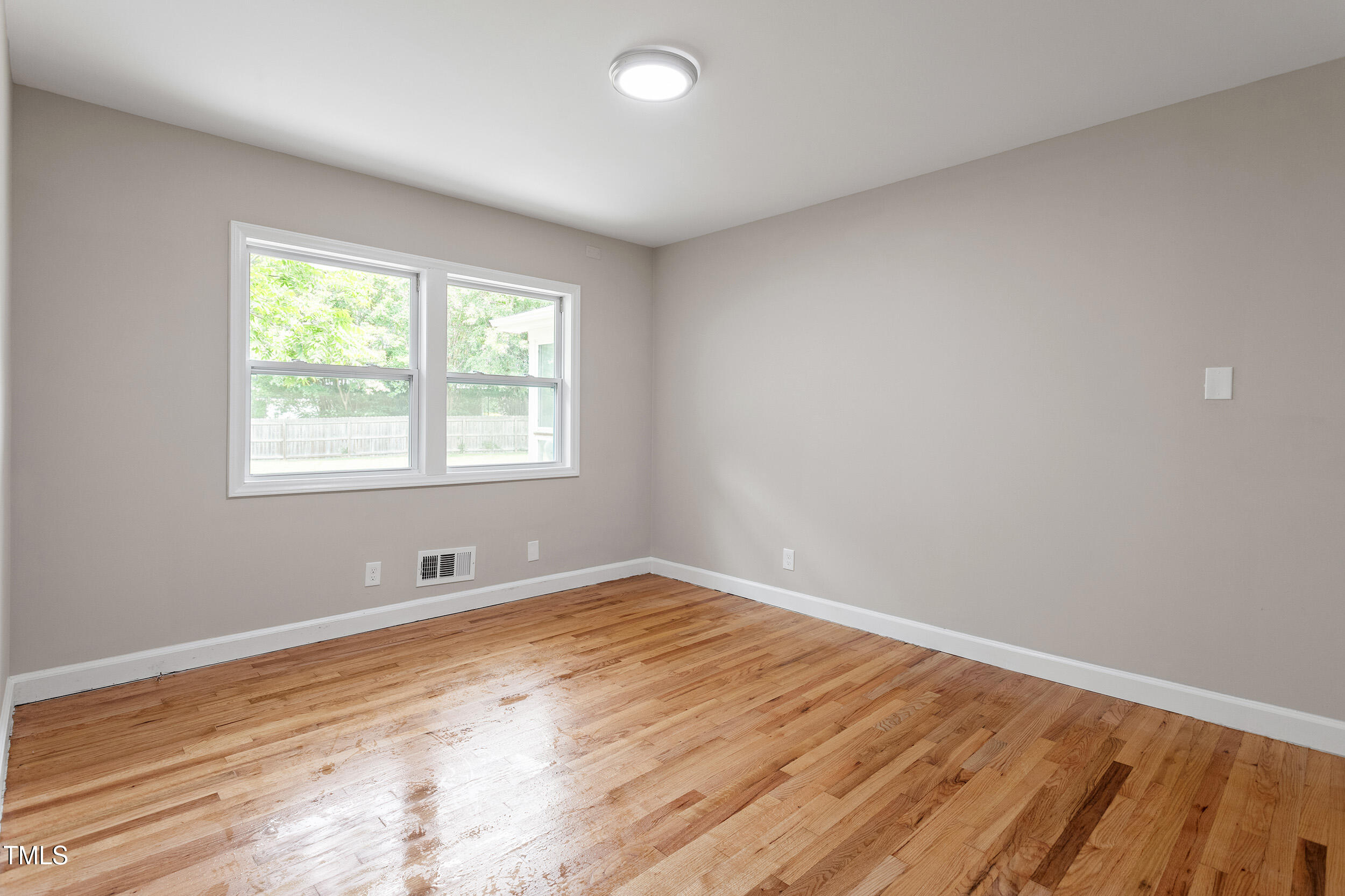 3325 Old Buffalo Road Raleigh, NC 27604 - Photo 18 of 26 an empty room with wooden floor and windows