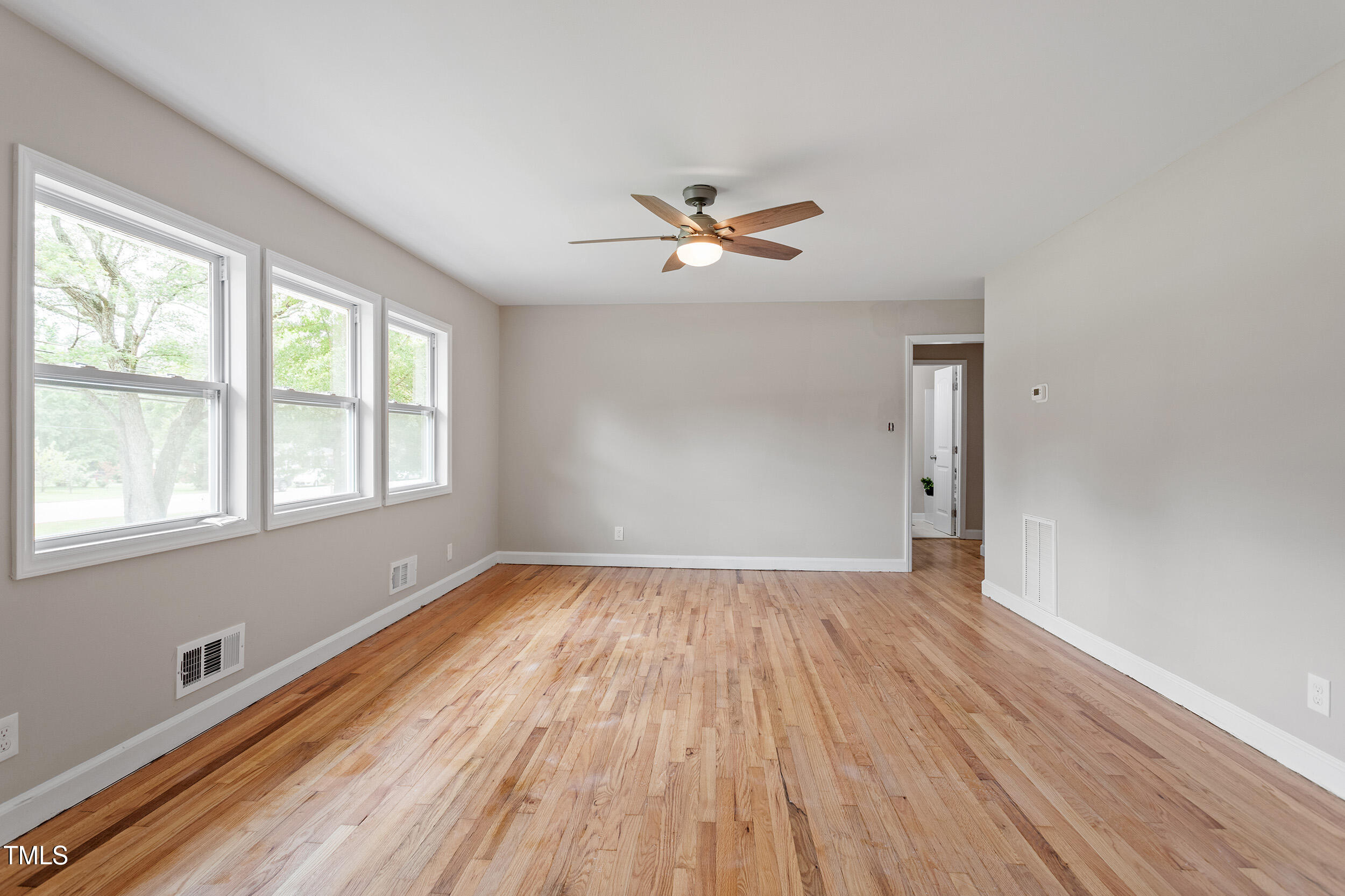 3325 Old Buffalo Road Raleigh, NC 27604 - Photo 2 of 26 an empty room with wooden floor and windows