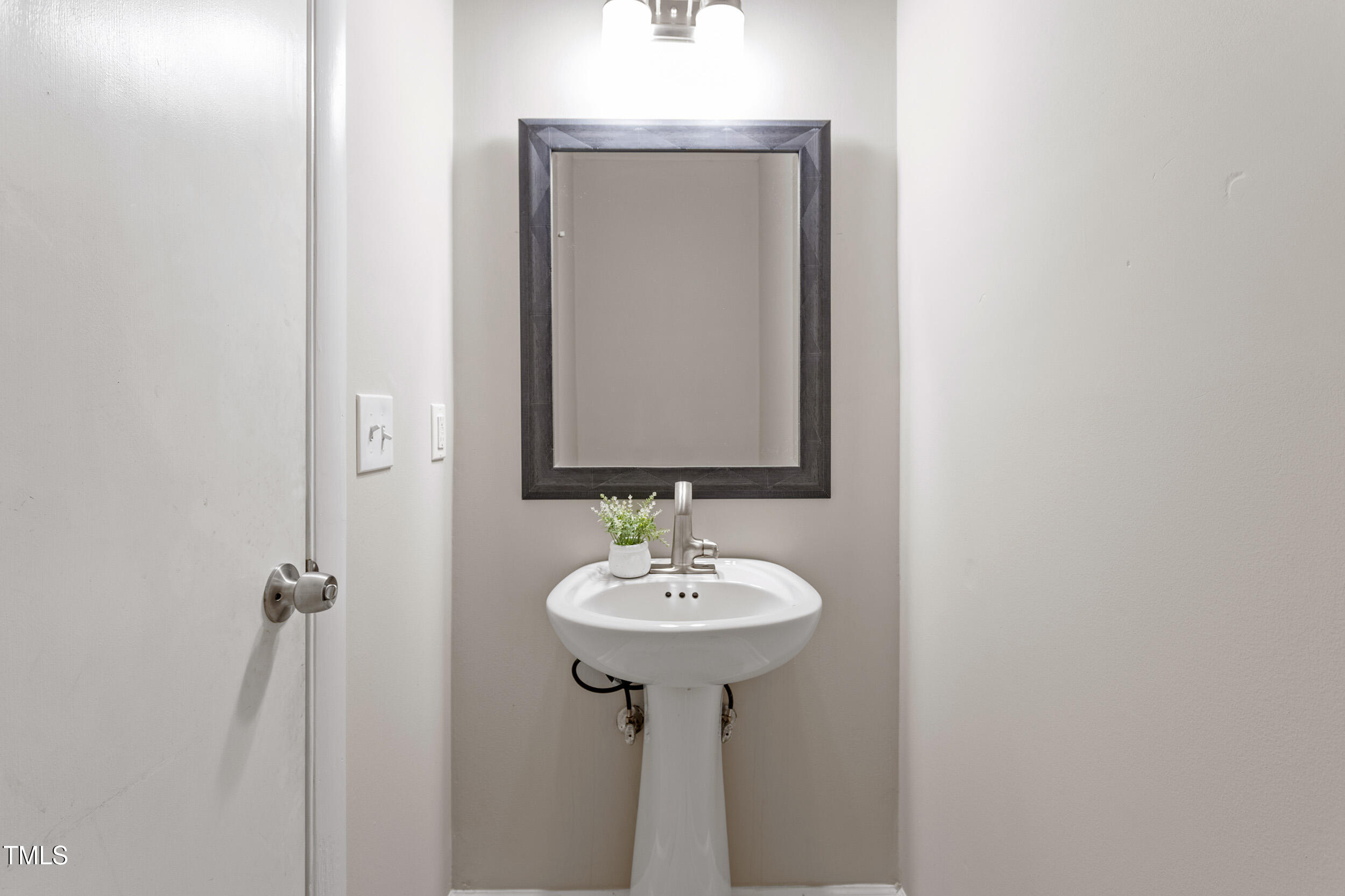 3325 Old Buffalo Road Raleigh, NC 27604 - Photo 24 of 26 a bathroom with a sink and a mirror