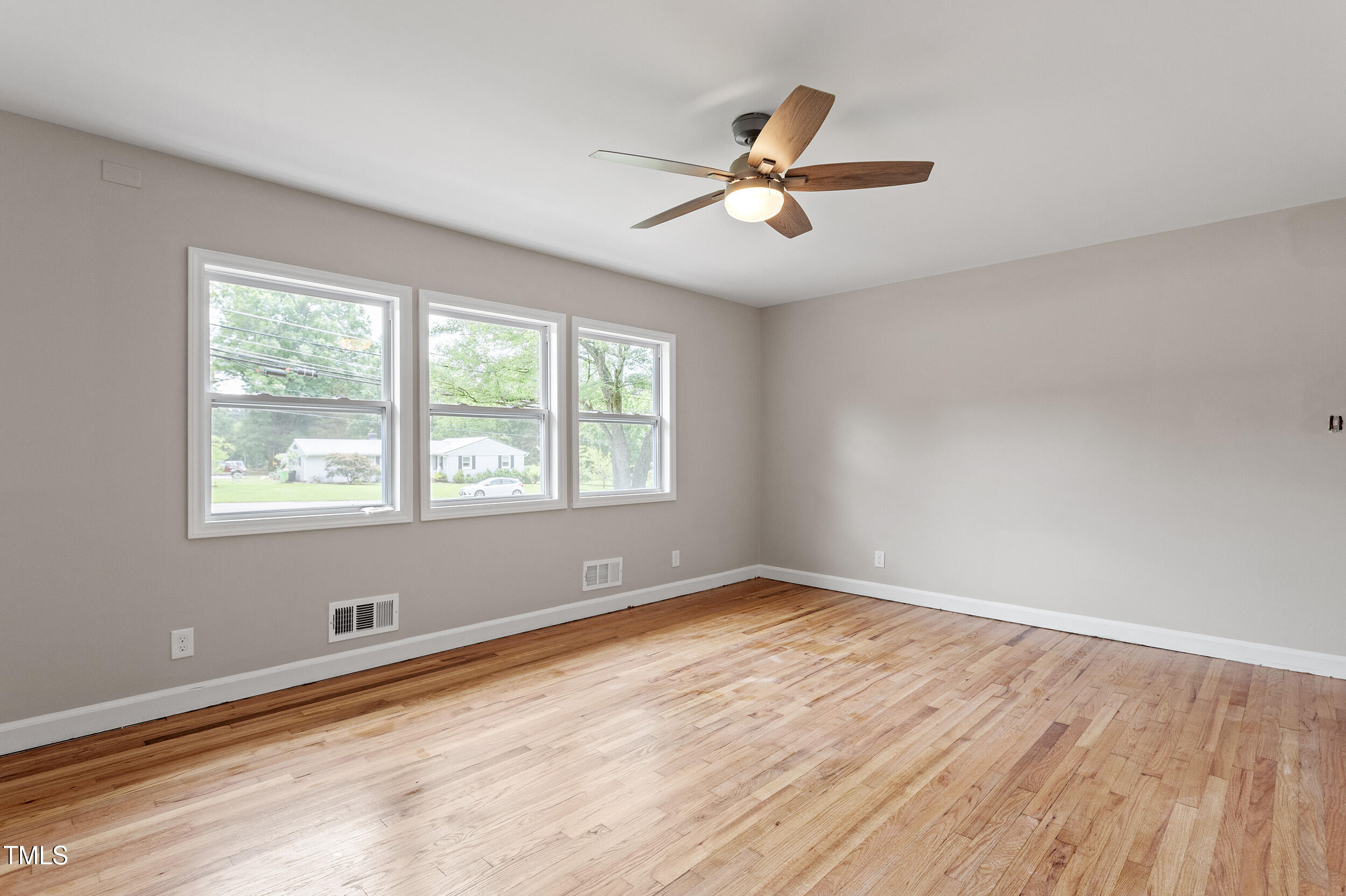 3325 Old Buffalo Road Raleigh, NC 27604 - Photo 6 of 26 a view of empty room with wooden floor and fan