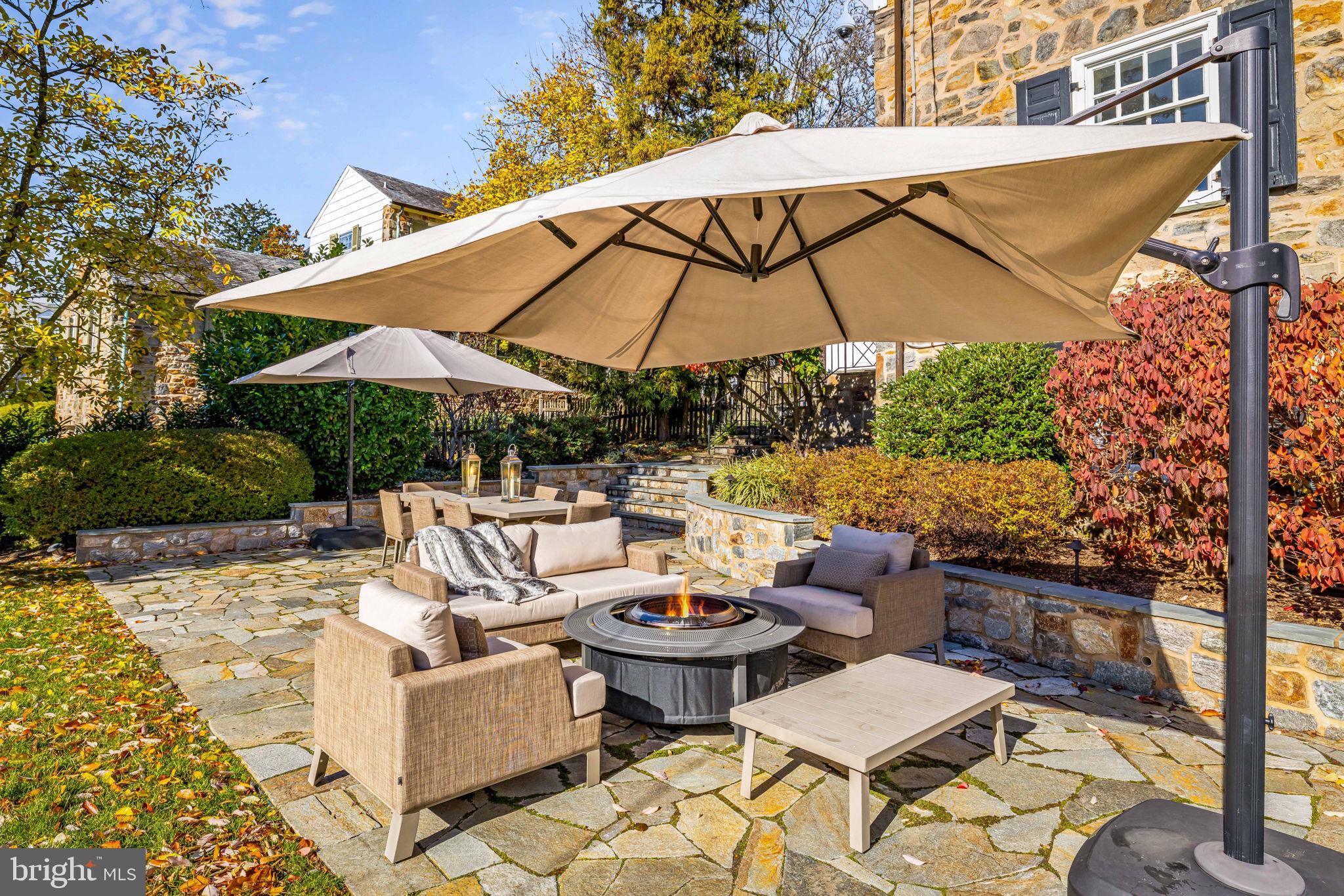 115 Tunbridge Road Baltimore, MD 21212 - Photo 9 of 13 a view of a patio with couches table and umbrella under an umbrella