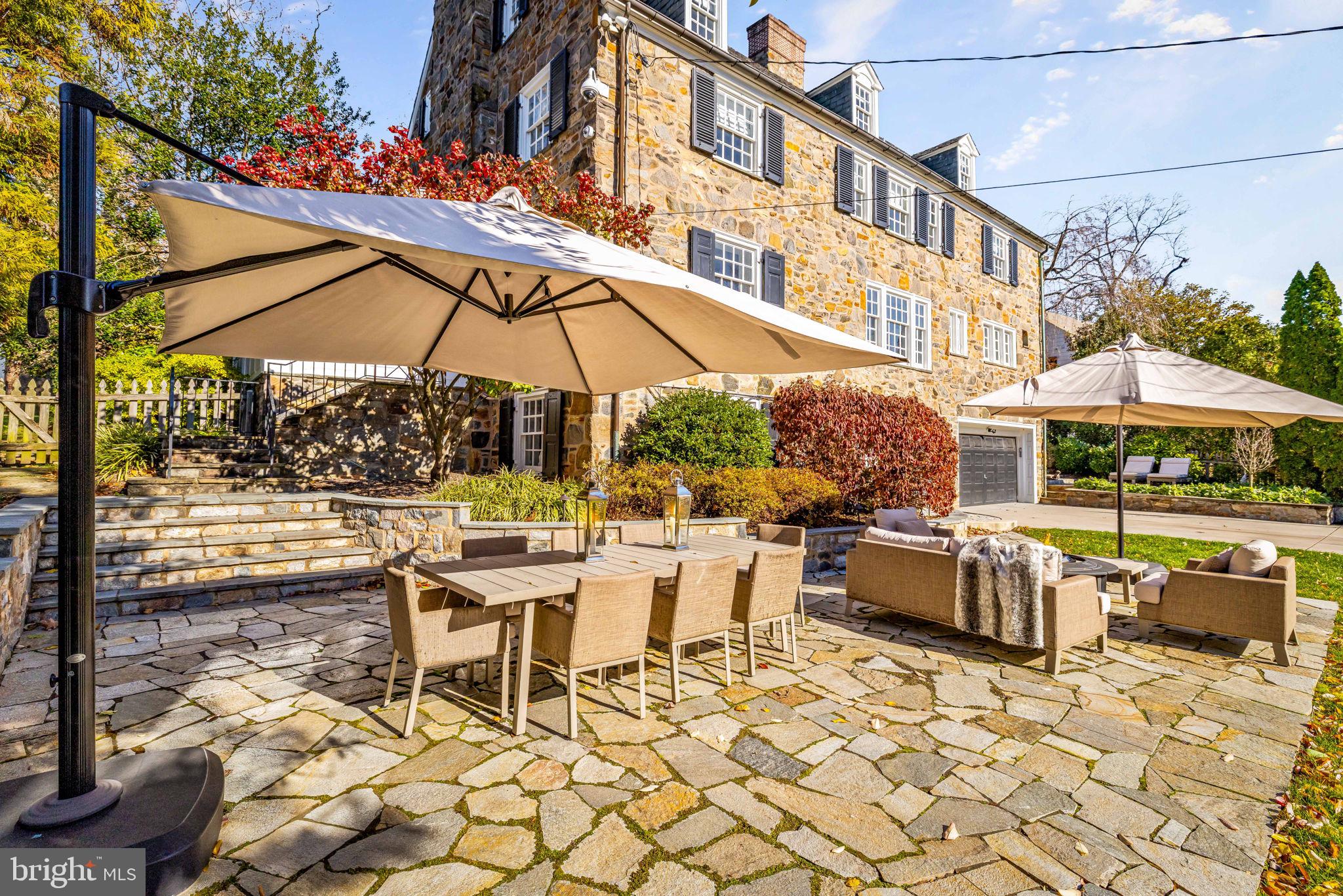 115 Tunbridge Road Baltimore, MD 21212 - Photo 10 of 13 a view of a patio with a table and chairs under an umbrella