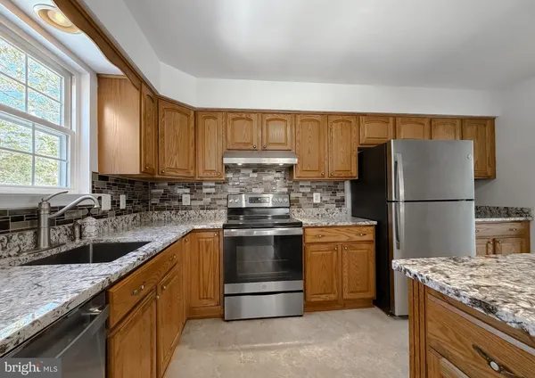 a living room with furniture a rug and a book shelf