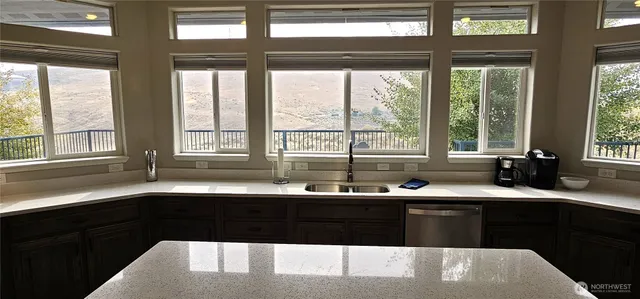 a kitchen with a sink and large window