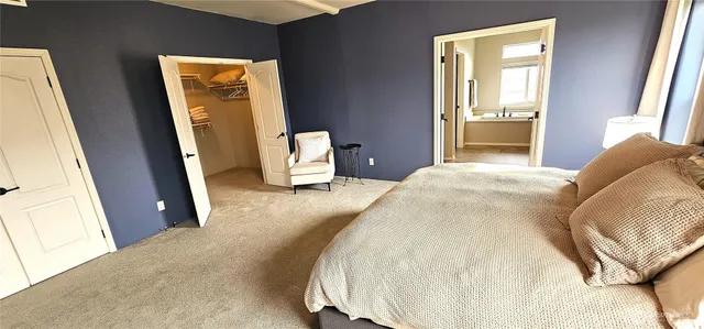 a bedroom with a bed and a mirror