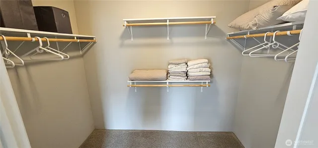 a view of walk in closet with empty racks