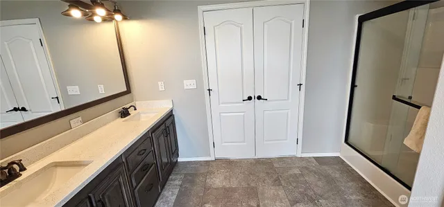 a view of bathroom with a sink a mirror and a shower