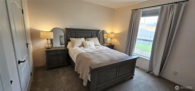 a bed sitting in a bedroom next to a window