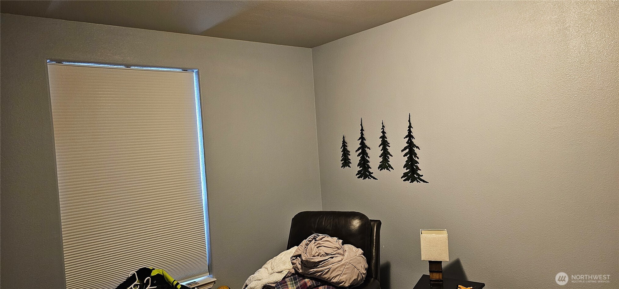 435 Maringo Road Ephrata, WA 98823 - Photo 34 of 40 a bedroom with a bed and a chandelier