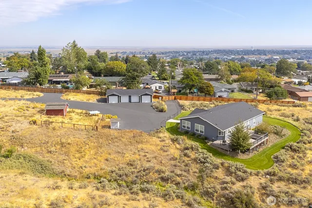 an aerial view of residential houses with outdoor space