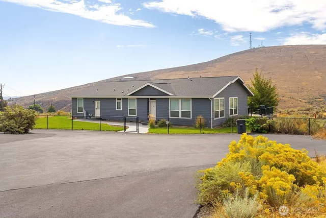 a view of a house with swimming pool and a yard