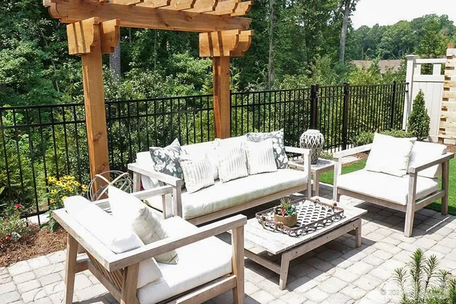 a view of a patio with couches and a table and chairs with wooden floor