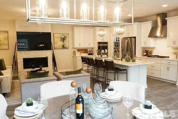 a living room with furniture a fireplace a rug and a window