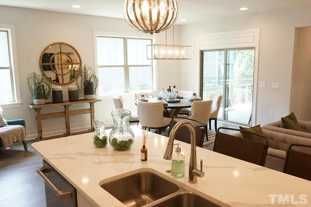 a view of a dining room with furniture a chandelier and wooden floor