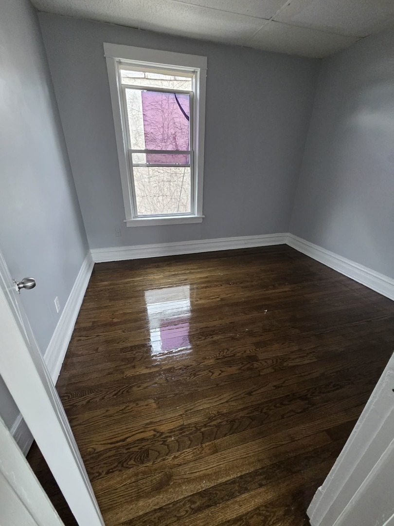 2704 East 77th Street, Unit 2 Chicago, IL 60649 - Photo 7 of 12 a view of a hallway with wooden floor