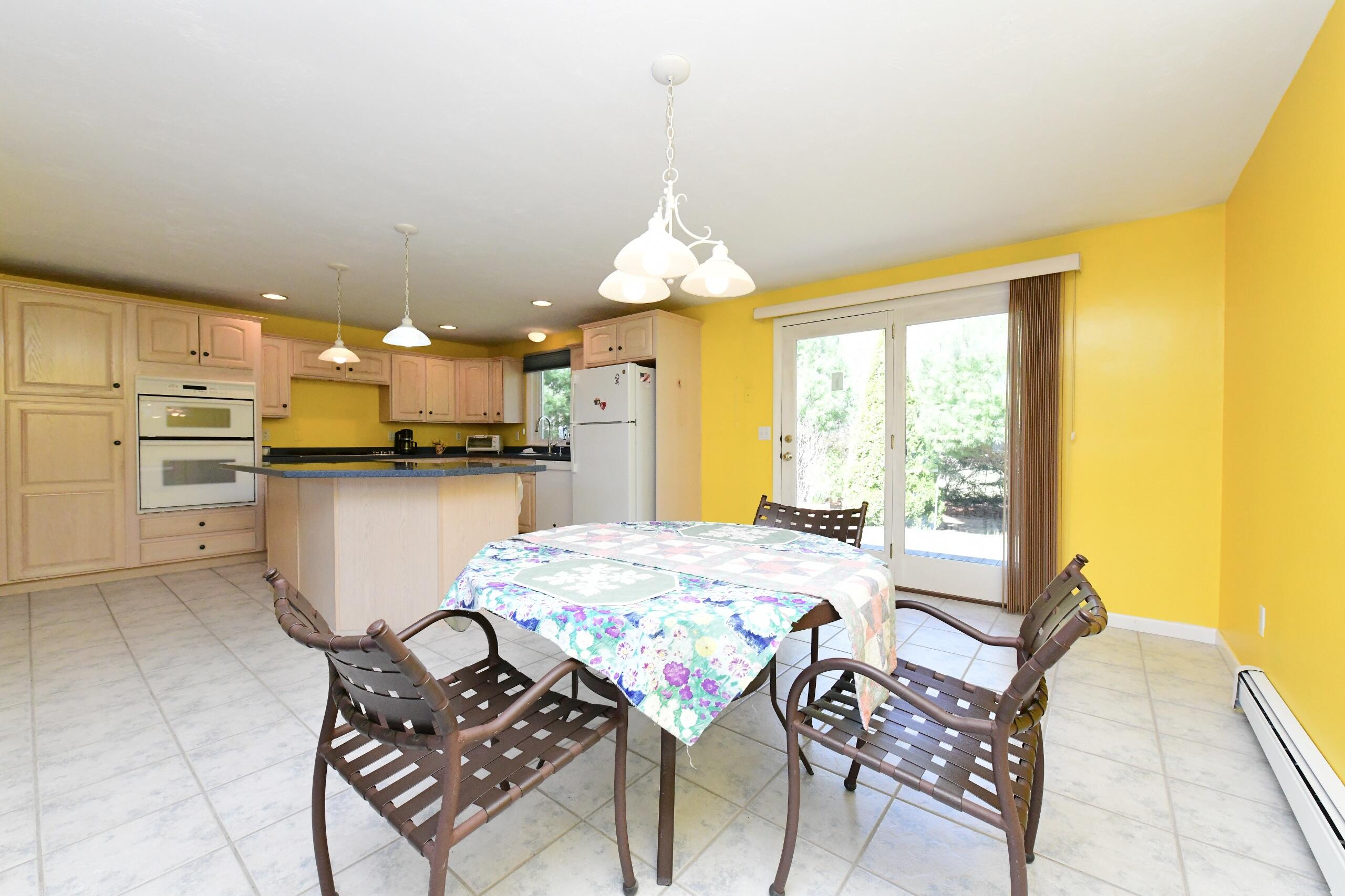 25 Andrew Road Sagamore Beach, MA 02562 - Photo 11 of 45 a kitchen with a table and chairs in it