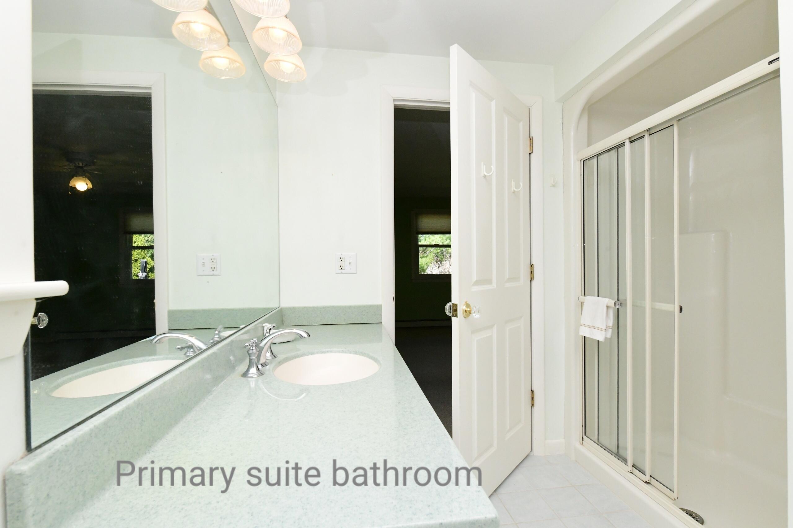 25 Andrew Road Sagamore Beach, MA 02562 - Photo 14 of 45 a bathroom with a sink a mirror and a shower