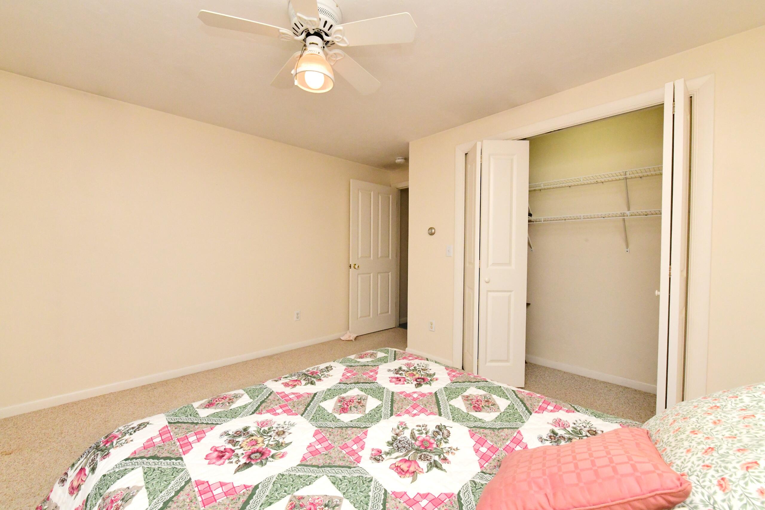 25 Andrew Road Sagamore Beach, MA 02562 - Photo 18 of 45 a bedroom with a bed and a chandelier fan