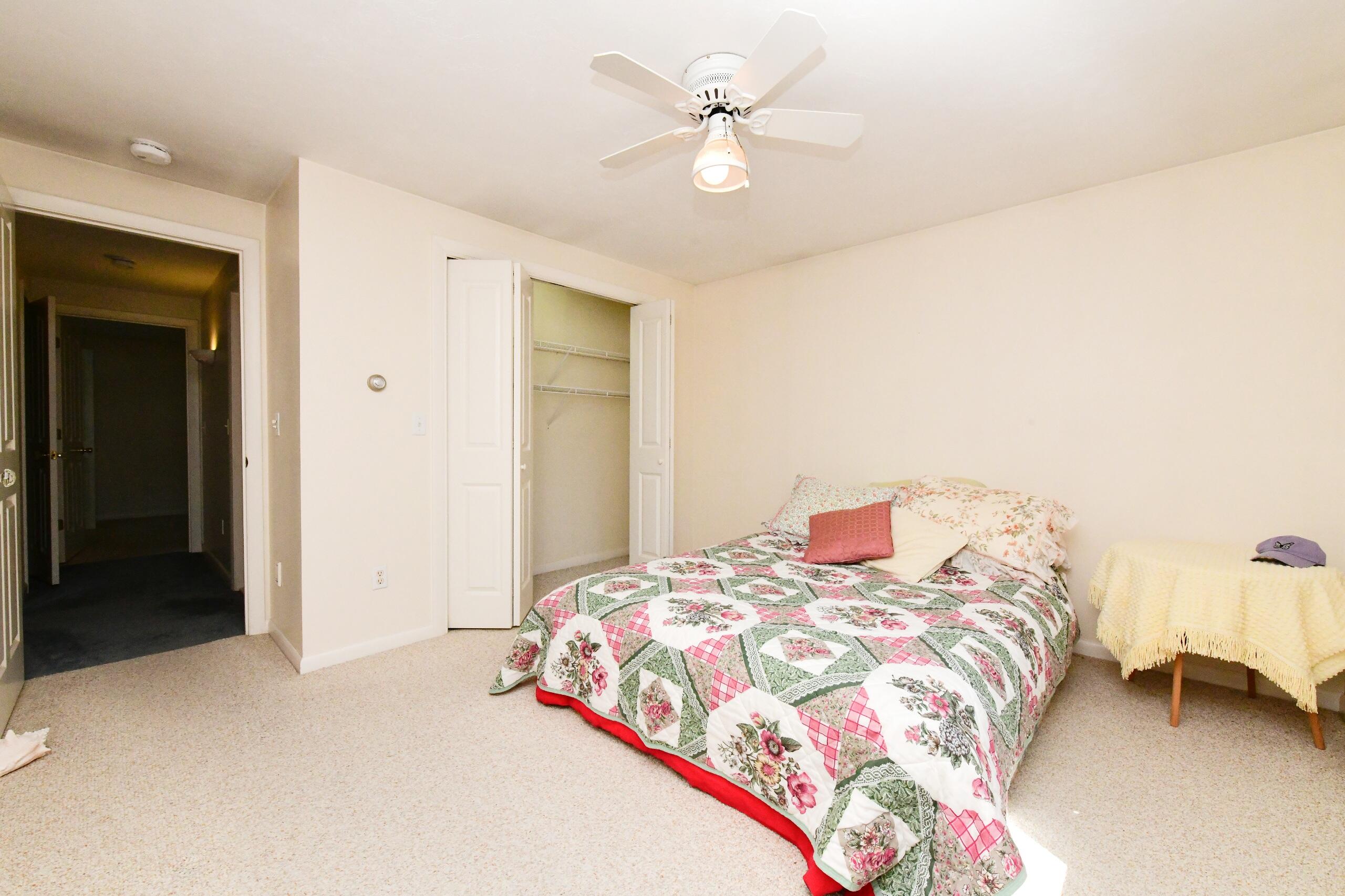 25 Andrew Road Sagamore Beach, MA 02562 - Photo 19 of 45 a bedroom with a bed and a chandelier
