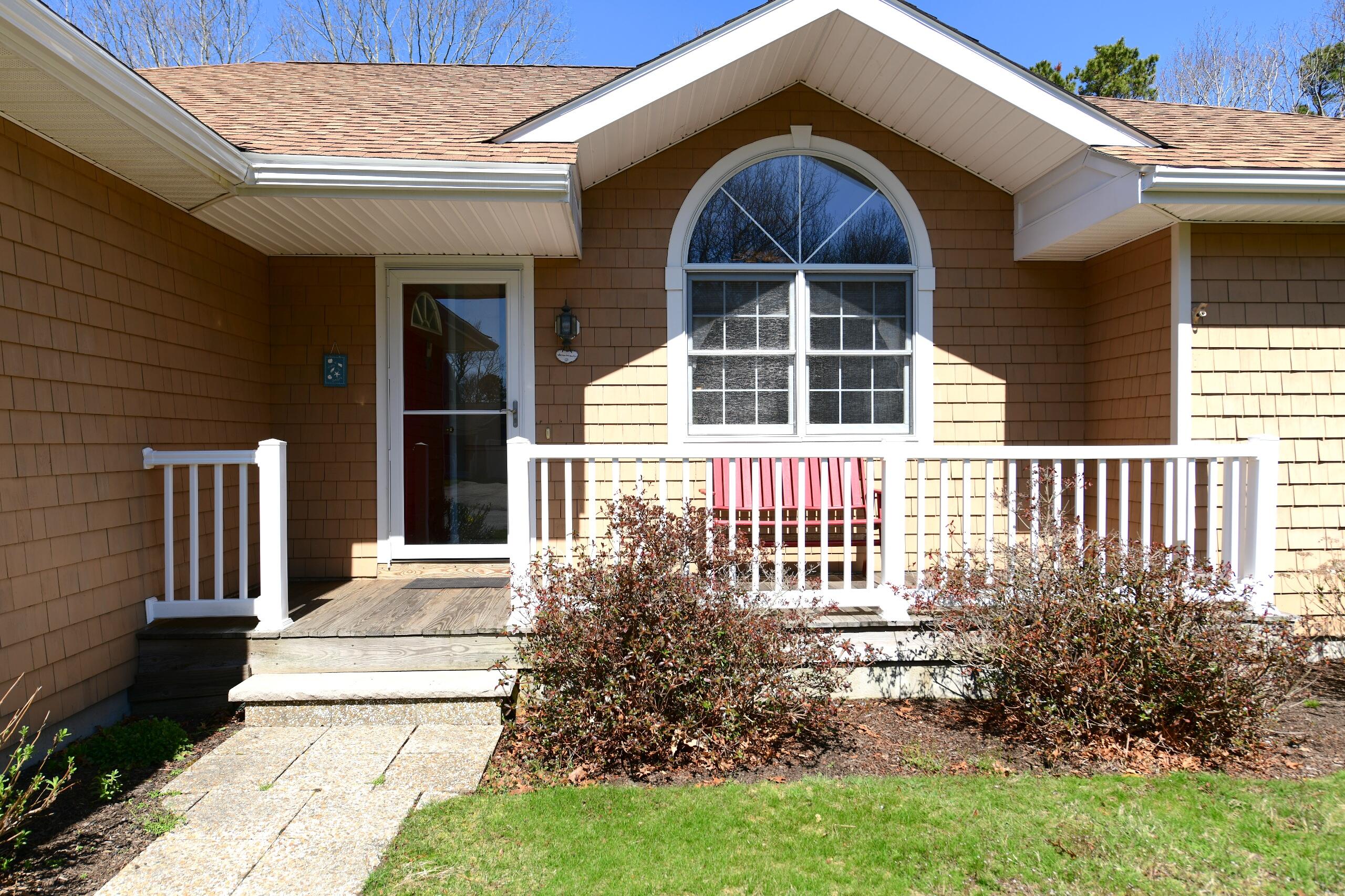 25 Andrew Road Sagamore Beach, MA 02562 - Photo 3 of 45 a front view of a house with garden
