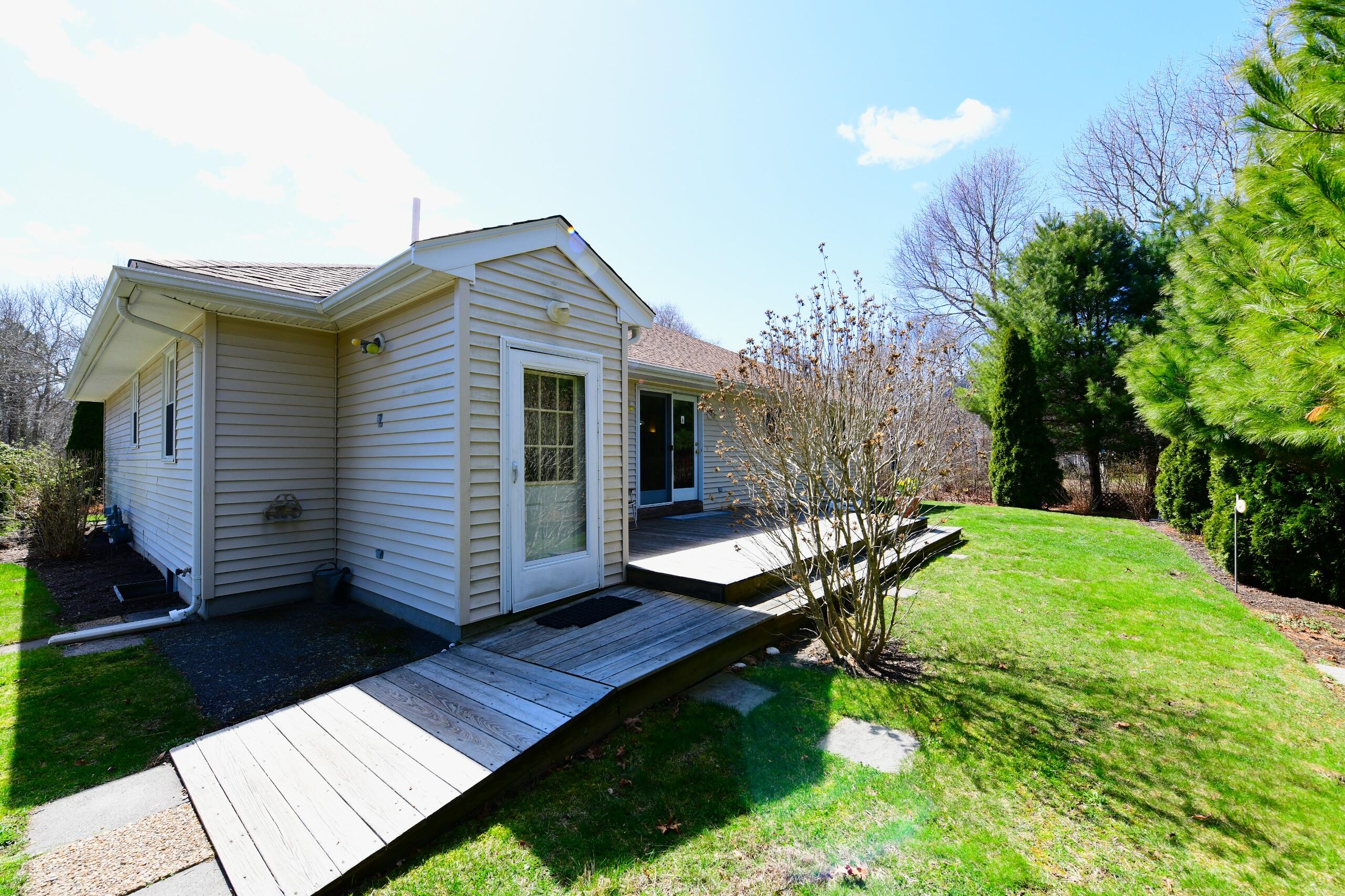 25 Andrew Road Sagamore Beach, MA 02562 - Photo 39 of 45 a view of a house with backyard and sitting area