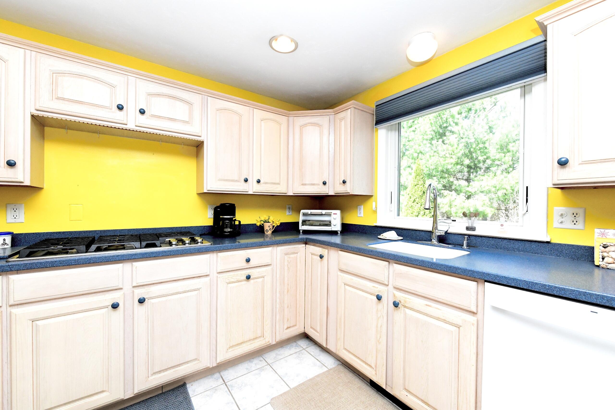 25 Andrew Road Sagamore Beach, MA 02562 - Photo 5 of 45 a kitchen with white cabinets and window