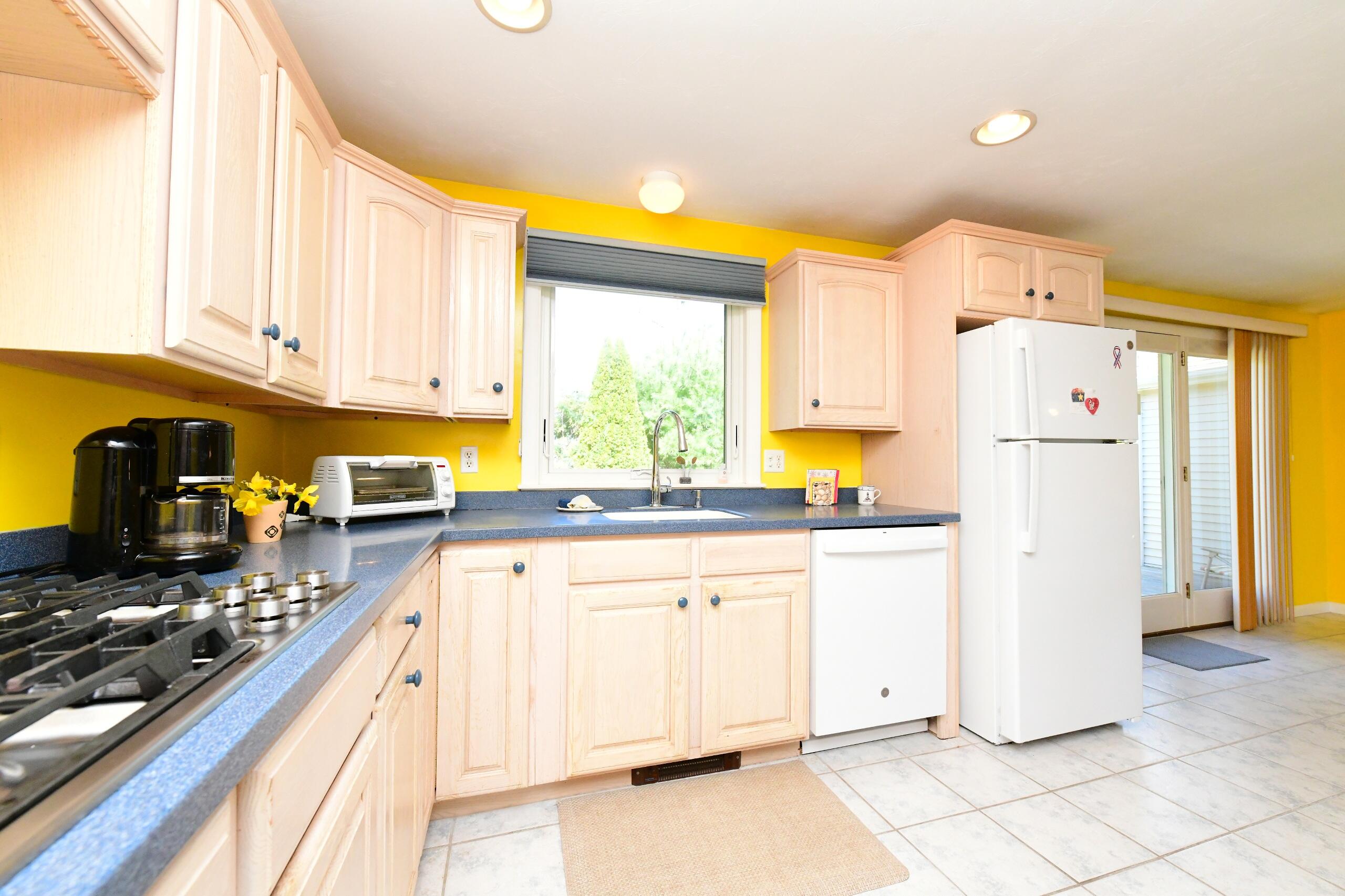 25 Andrew Road Sagamore Beach, MA 02562 - Photo 6 of 45 a kitchen with a refrigerator a stove a sink and a cabinets