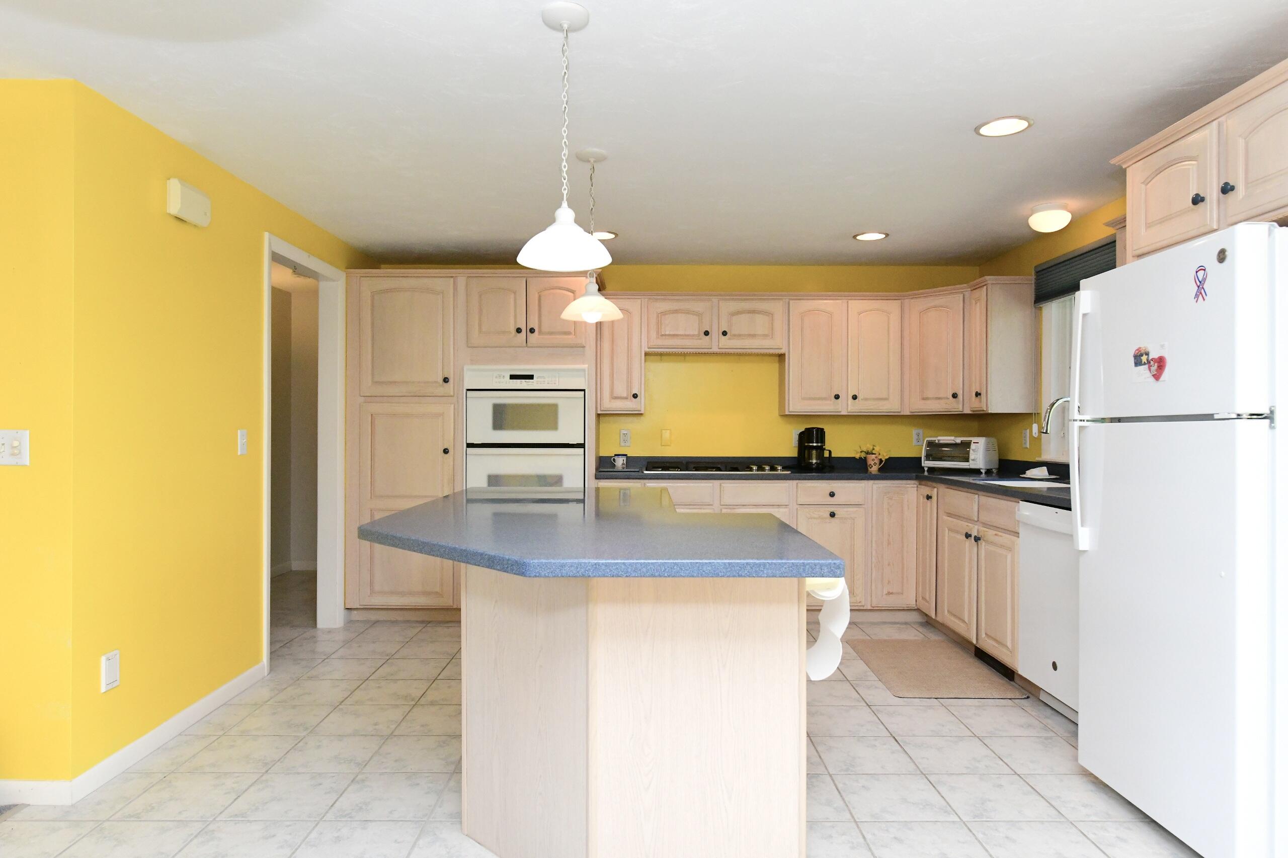 25 Andrew Road Sagamore Beach, MA 02562 - Photo 10 of 45 a kitchen with kitchen island a sink a counter top space and cabinets