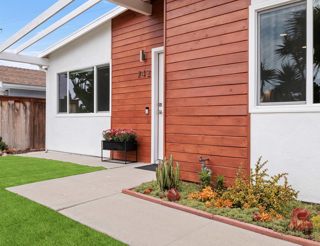 742 Snapdragon Street Encinitas, CA 92024 - Photo 3 of 22 a front view of a house with a yard and garage