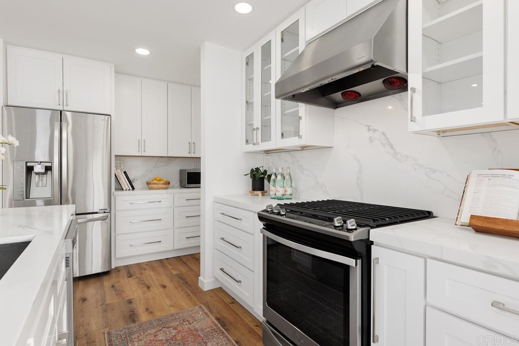 742 Snapdragon Street Encinitas, CA 92024 - Photo 6 of 22 a kitchen with white cabinets and appliances