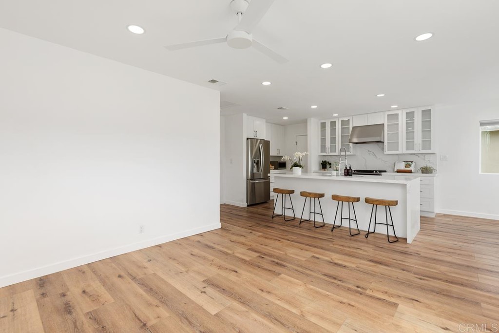 742 Snapdragon Street Encinitas, CA 92024 - Photo 7 of 22 a kitchen with stainless steel appliances kitchen island granite countertop a refrigerator and a stove top oven